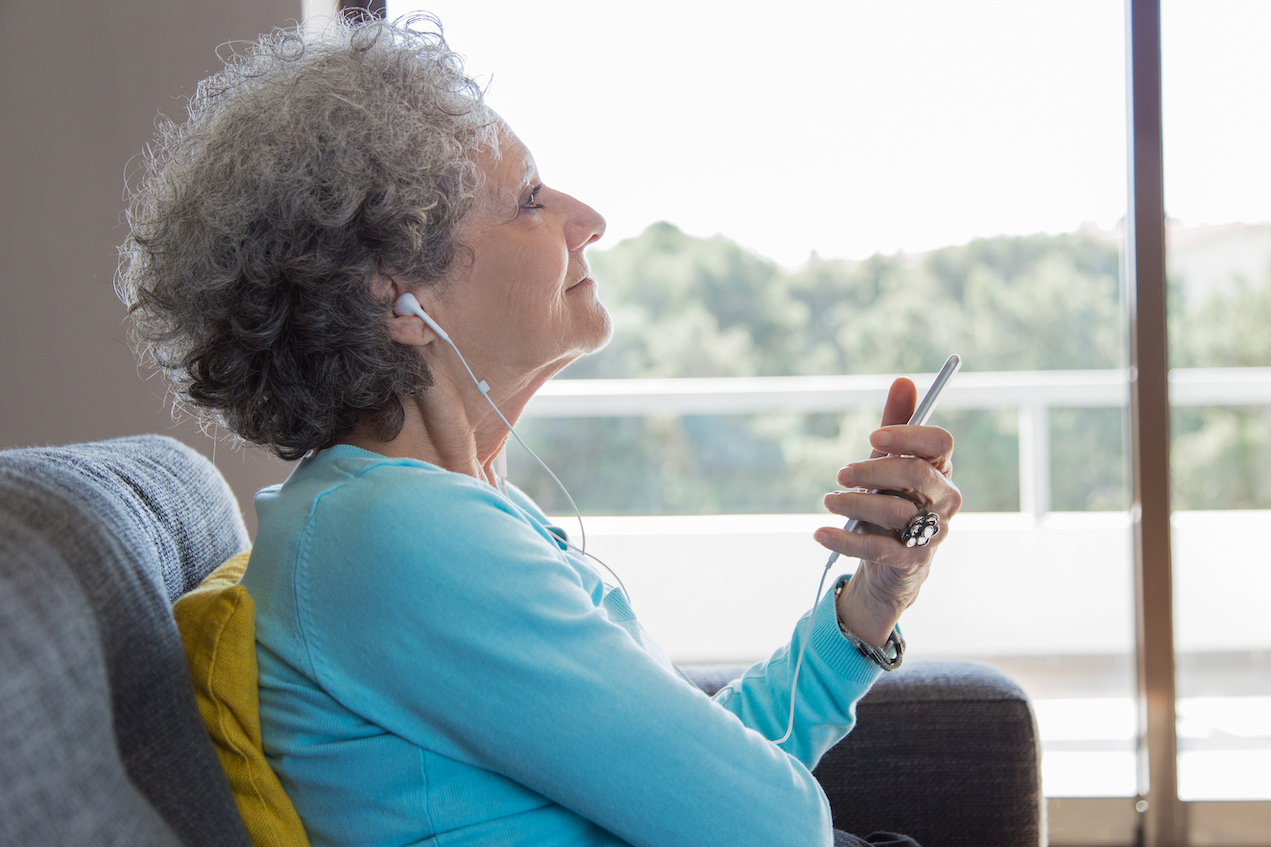 A woman using headphones and music therapy for chronic pain