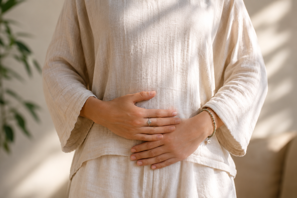 diagphram breathing for trauma and stress A person holding their stomach as they use diaphragm breathing for stress reduction.